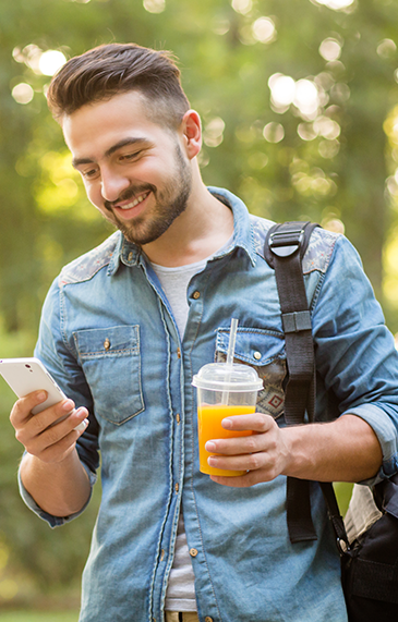 Man Looking At His Phone Smiling in Belleville, IL